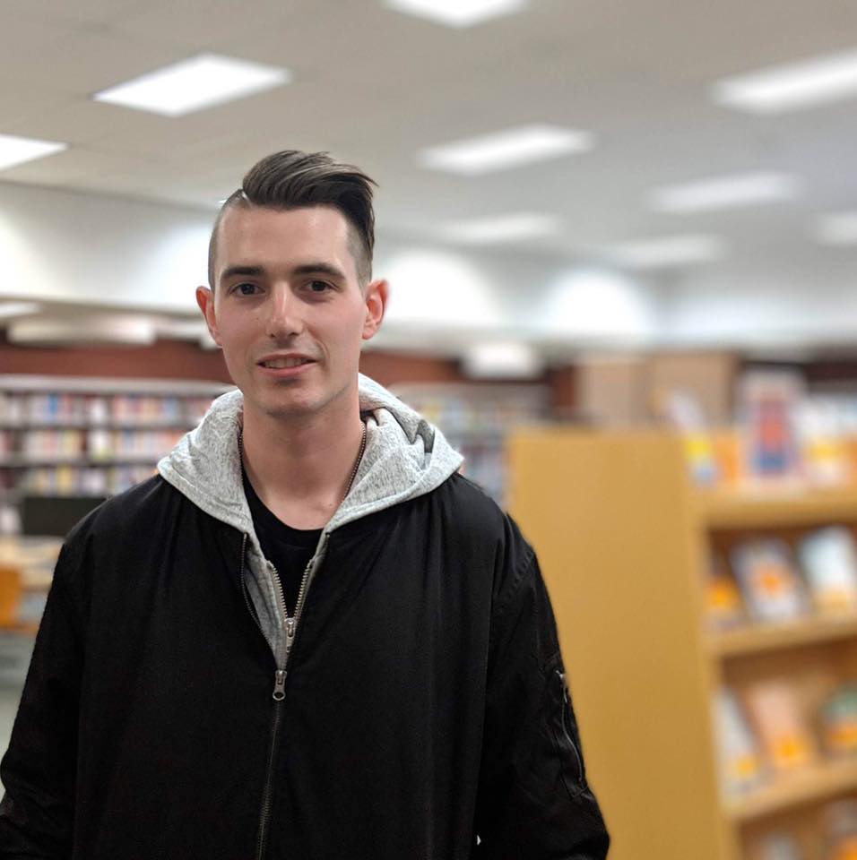 Photo of Matthew Bonn in a library